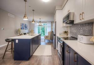 a kitchen with blue cabinets and a counter top at BRAND-NEW LUXURY SUITE in DOON SOUTH, min to 401 in Kitchener