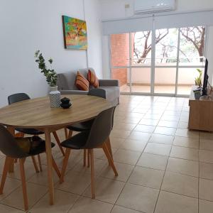 a living room with a table and a couch at Temporario en Resistencia con cochera in Resistencia