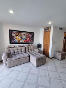 a living room with a couch and two ottomans at Balcón Azul in Santa Marta