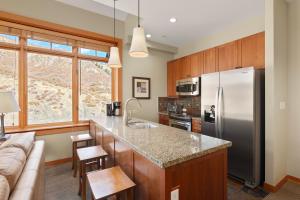 a kitchen with a stainless steel refrigerator freezer at Pinecone Perch Capitol Peak Lodge #3227 in Snowmass Village