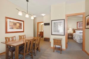 a dining room with a table and a bedroom at Pinecone Perch Capitol Peak Lodge #3227 in Snowmass Village