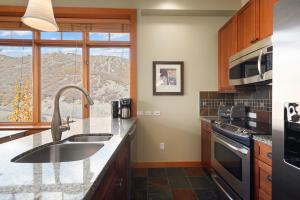 a kitchen with a sink and a stove top oven at Pinecone Perch Capitol Peak Lodge #3227 in Snowmass Village +22 photos
