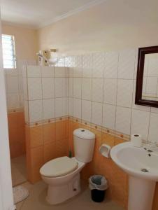 a bathroom with a toilet and a sink at Villa Del Pueblo Inn in Panglao