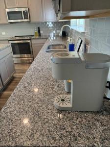 a kitchen with a counter with a sink and a kitchen counter at The White Haus A Cozy New Braunfels Cottage in New Braunfels