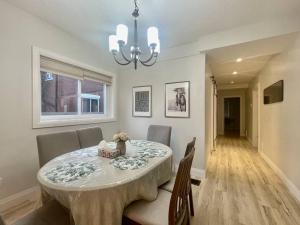a dining room table with a teddy bear sitting on it at Stylish 3-bdrm suite w free Parking in Kitchener