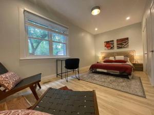 a bedroom with a bed and a window at Stylish 3-bdrm suite w free Parking in Kitchener