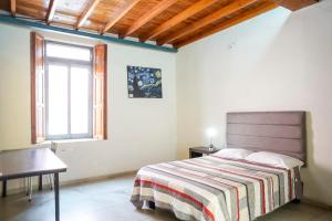 a bedroom with a bed and a window at Casa Morelos StayHouse in San Luis Potosí