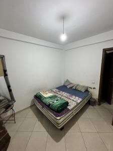 a small bedroom with a bed in a room at Guelou in Agadir