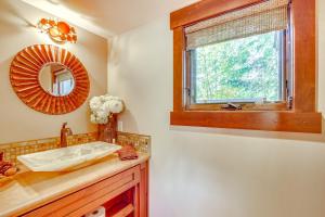 a bathroom with a sink and a mirror and a window at Golf Getaway with Hot Tub, Course Views in Cle Elum! in Cle Elum +27 photos