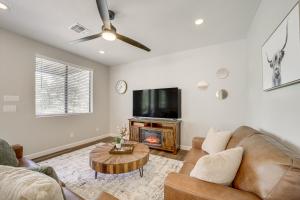 a living room with a couch and a tv at Games and Outdoor Seating Cabin in Scenic Payson! in Payson