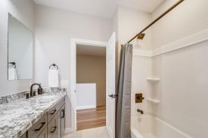 a bathroom with two sinks and a tub and a shower at Games and Outdoor Seating Cabin in Scenic Payson! in Payson +29 photos