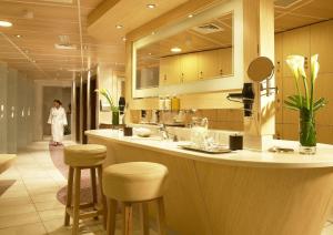 a kitchen with two sinks and a large mirror at Inchydoney Island Lodge & Spa in Clonakilty