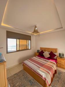 a bedroom with a large bed and a window at Deluxe Apartment At Amouage Anza in Agadir