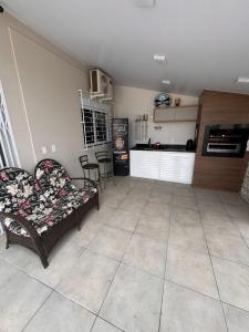 a living room with a couch and a kitchen at casa canasvieiras 100 m praia in Florianópolis +6 photos