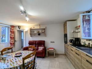 a kitchen and dining room with a table and a chair at Évasion nature en Brenne : maison avec jardin, activités et économie près de Châteauroux - FR-1-591-58 in Luant +12 photos
