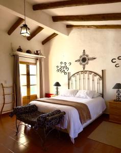 a bedroom with a large bed and a window at El Pueblito Hotel Boutique in Samaipata