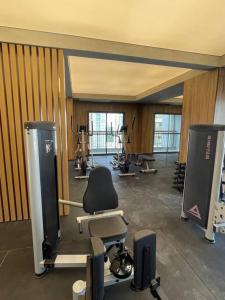 a room with a gym with a chair and weights at 2307 Uwin Brooklin melhor custo benefício ao lado do metrô in Sao Paulo +6 photos