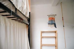 a room with two bunk beds and a ladder at 4 Elementos Hostal in San Juan La Laguna
