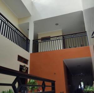 a living room with a tv and a balcony at Hotel Raízes in Bom Conselho