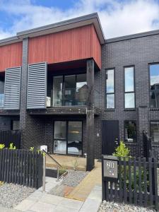 a brick building with a sign in front of it at Luxury Villa- Long Bay Manhattan in Auckland