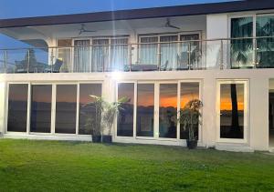 a house with a view of the sunset at Sunset Suite - Beach Front Estates in Saipan