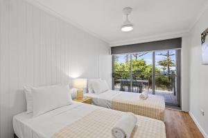 Rúm í herbergi á Malibu Apartments