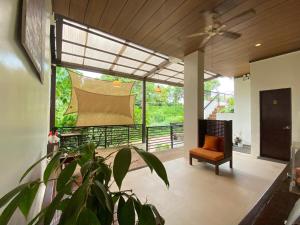 a living room with a chair and a plant at Vela Terraces Hotel in Coron