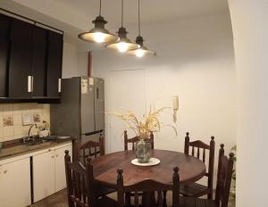 a kitchen with a table with a vase of flowers on it at Corrientes Grand Apart in Corrientes