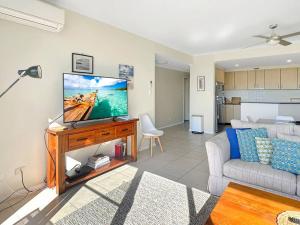 阿沃卡海滩Unit 11 - Avoca Palms Resort的配有平板电视和沙发的客厅