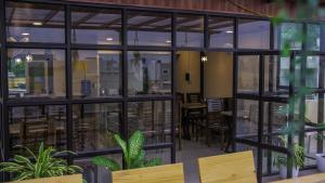 a rendering of a restaurant with tables and windows at Radhe Suites in Hyderabad