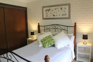 a bedroom with a bed with a green pillow on it at Church St in Bright