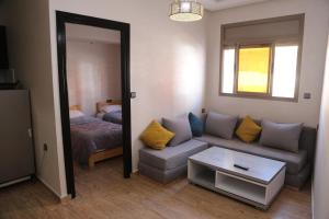 a living room with a couch and a bed at Nomad surf lodge 2 in Imsouane