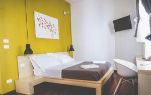 a bedroom with a bed and a desk and a chair at Bio Hotel Palermo in Palermo
