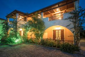 an exterior view of a house at night at Olga Studios in Vasilikos