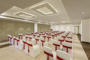 a conference room with white and red chairs at Ginger Vishakhapatnam Gajuwaka in Visakhapatnam