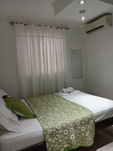 Postel nebo postele na pokoji v ubytování Hotel La Leyenda Vallenata