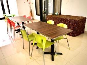 a group of tables and chairs in a room at Serafinna Guest House in Surabaya