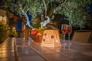 a table with a lantern and wine glasses on it at Olga Studios in Vasilikos