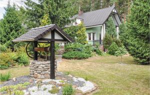 a gazebo in the yard of a house at Awesome Home In Rybakowo With Wifi in Santoczno