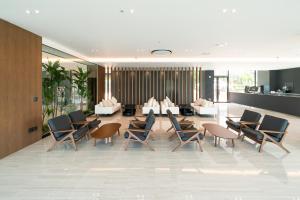 a lobby with chairs and tables in a building at Yeosu OANDF Hotel in Yeosu
