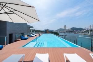 a swimming pool on the roof of a building at Yeosu OANDF Hotel in Yeosu