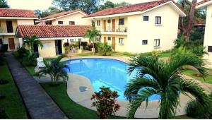 a large swimming pool in front of a house at Sweet Torres Estudio 2pers in Coco