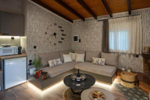 a living room with a couch and a table at PLATS Traditional Living in Dáfni
