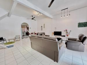 a living room with two couches and a tv at Home10#6pax#Netflix#NearAeonAlma&Lotus#BM# in Bukit Mertajam +19 photos
