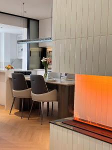 a kitchen with a table and chairs and a fireplace at XinTianDi 3 Bedrooms Newly Luxury Designer Decoration Intelligent Control System in Shanghai