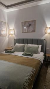 a bedroom with a bed with two lights on the wall at Djina mmm1 in Veliko Gradište