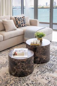 a living room with a couch and a coffee table at Frank Porter - Diamond, Tiara Residences in Dubai