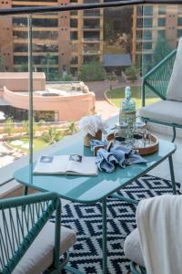 a blue table with a book on a patio at Frank Porter - Diamond, Tiara Residences in Dubai