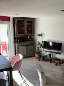 a living room filled with chairs and a tv at Pinky House in Peynier