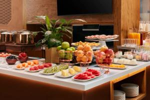 a buffet of fruits and vegetables on a table at NH Collection Madrid Palacio de Tepa in Madrid
